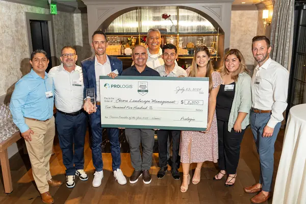 Encore team accepting an oversized check from Prologis at the Vendor of the Year celebration