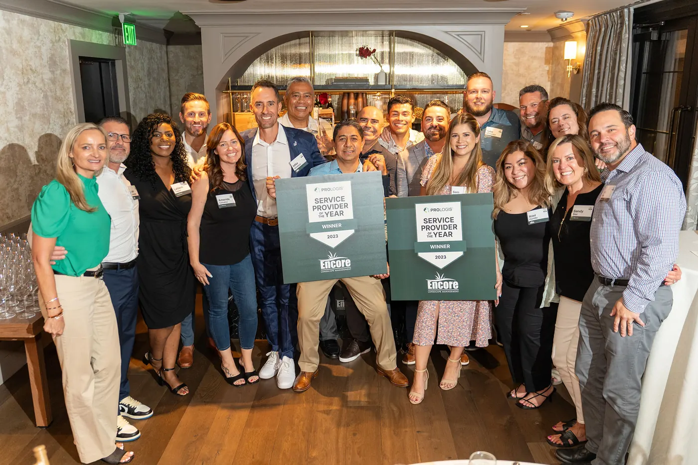 Encore team members holding Prologis Service Provider of the Year signs at the awards event