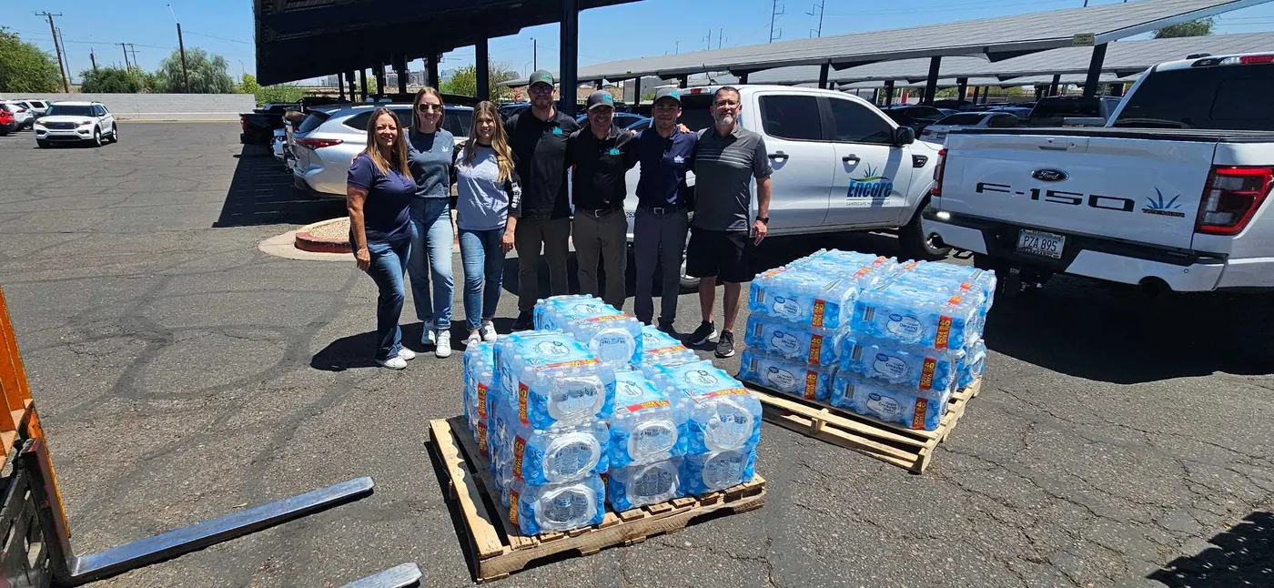 Encore volunteers with pallets of bottled water at a St. Vincent de Paul donation drive