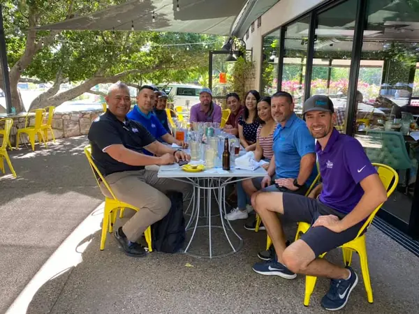 Encore team members sharing lunch on a restaurant patio