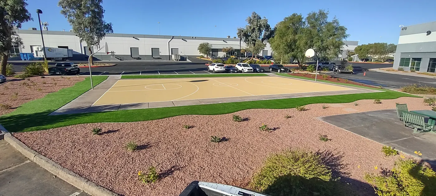 Wide view of a new artificial-turf and decomposed-granite area at Henderson Commerce Center